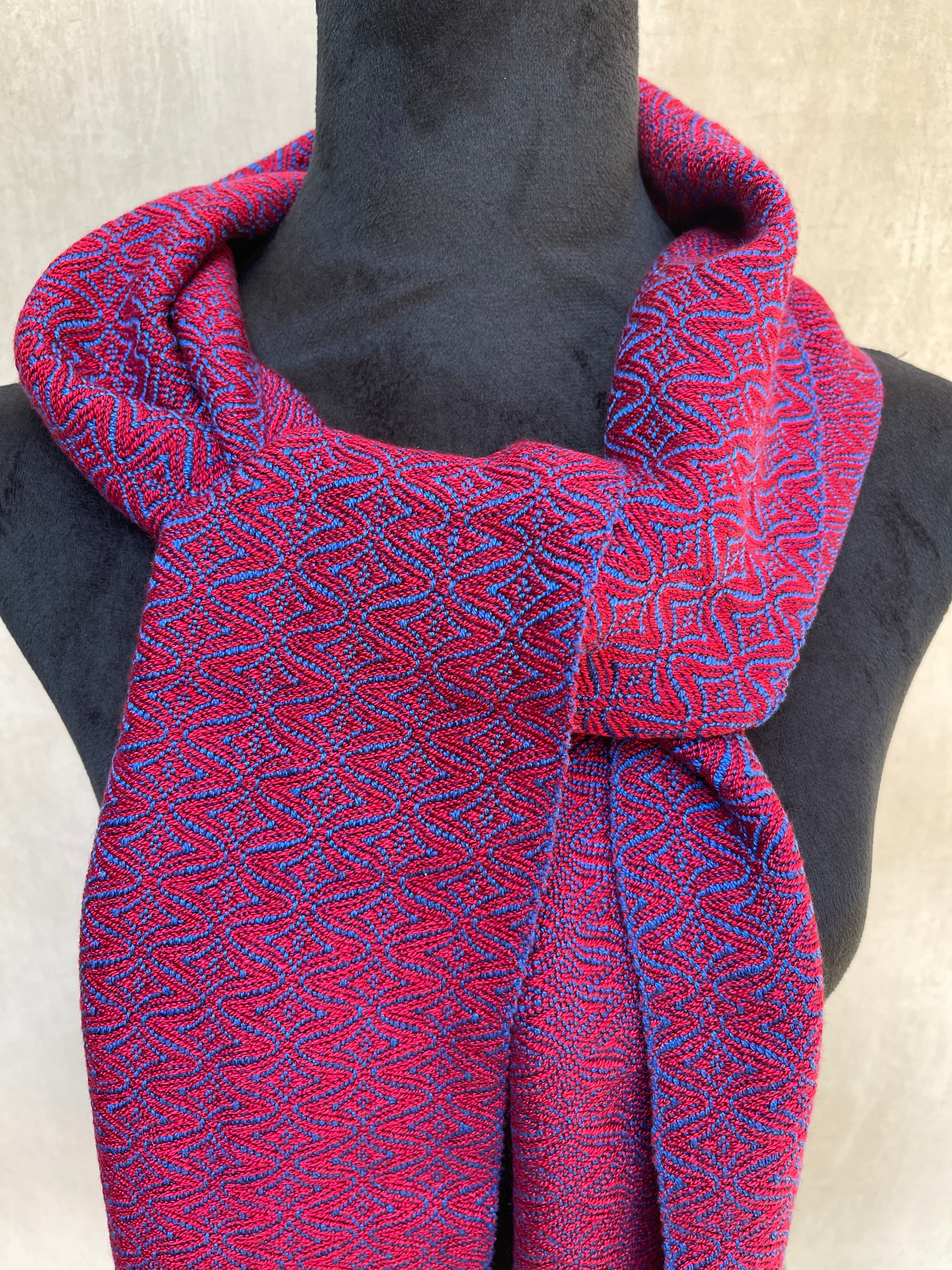 Close-up of a red and royal blue patterned scarf on a mannequin